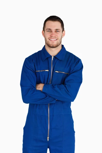 Smiling mechanic in boiler suit with folded arms — Stock Photo, Image