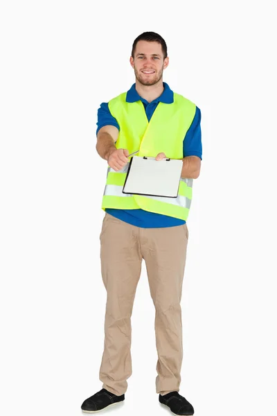 Smiling male in safety jacket handing his notes over — Stock Photo, Image