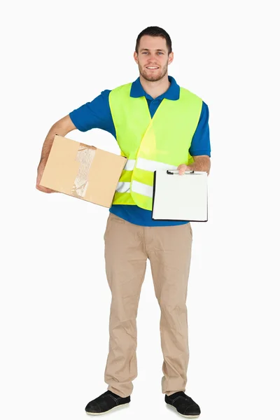 Smiling young delivery man asking for signature — Stock Photo, Image