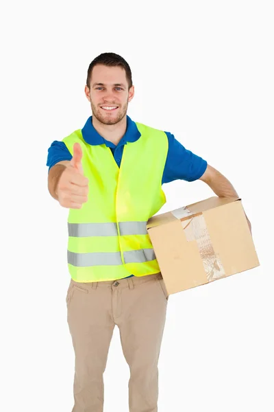 Smiling young delivery man giving approval — Stock Photo, Image