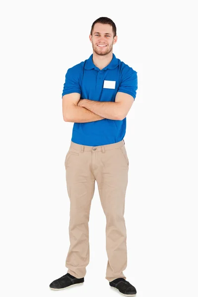Smiling young salesman with arms folded — Stock Photo, Image