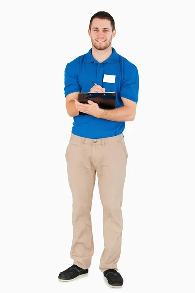 Smiling young salesman making a survey — Stock Photo, Image