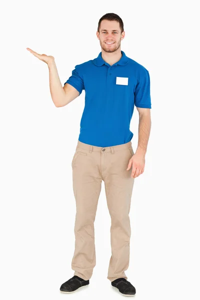Smiling young salesman presenting in his palm — Stock Photo, Image