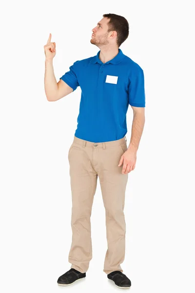 Young salesman looking and pointing upwards — Stock Photo, Image