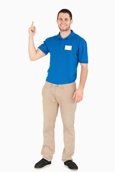 Smiling young salesman pointing upwards — Stock Photo, Image