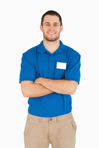 Smiling young salesman with folded arms — Stock Photo, Image