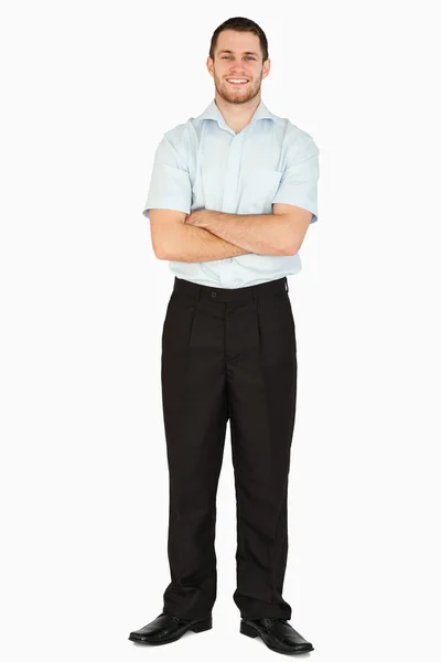 Smiling young post employee with arms folded — Stock Photo, Image