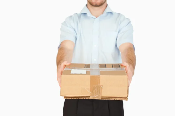 Parcel handed over by young post employee — Stock Photo, Image
