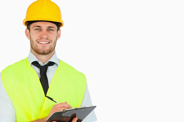 Smiling young lead worker with clipboard — Stock Photo, Image