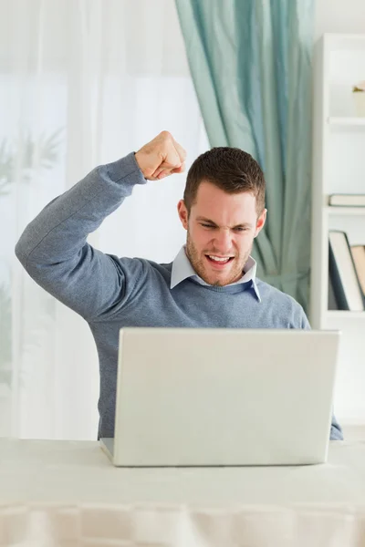 Businessman with raised fist in his homeoffice — Stock Photo, Image