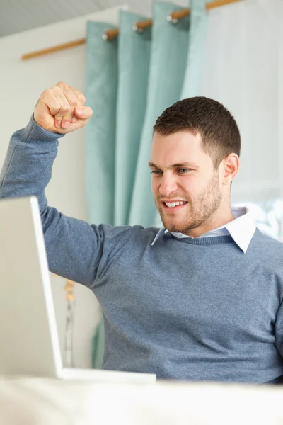 Businessman raising fist after success in his homeoffice — Stock Photo, Image