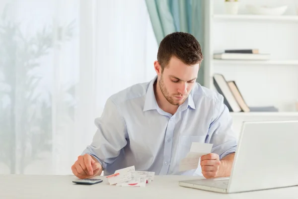 Businessman calculating his expenses — Stock Photo, Image
