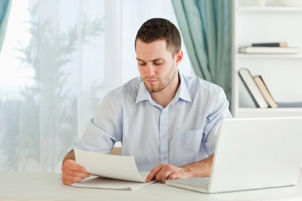 Businessman reading a letter in his homeoffice — Stock Photo, Image