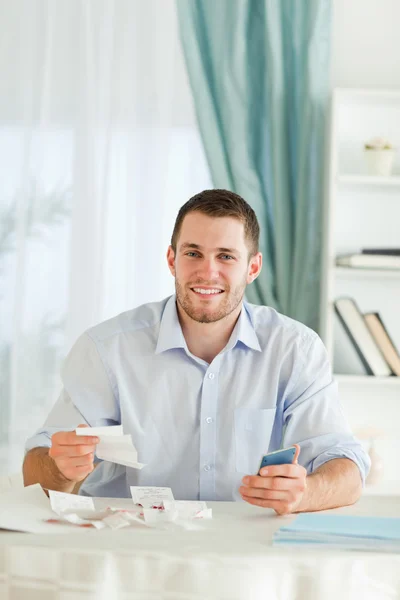 Businessman with hand calculator checking invoices — Stock Photo, Image