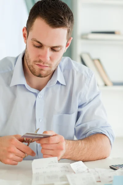 Businessman cutting his credit card — Stock Photo, Image