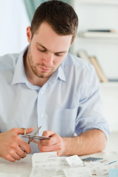 Businessman cutting his credit card into pieces — Stock Photo, Image