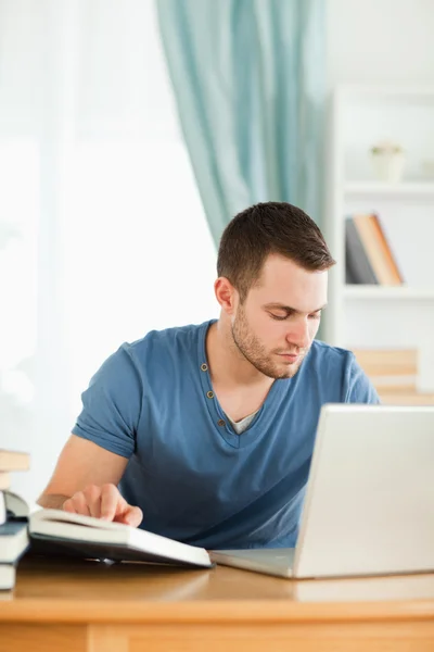 Student using the internet for his homework — Stock Photo, Image