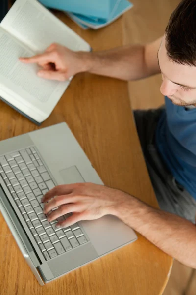 Student using notebook for his homework — Stock Photo, Image