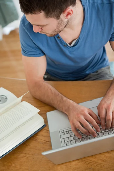 Student copying something from his book — Stock Photo, Image