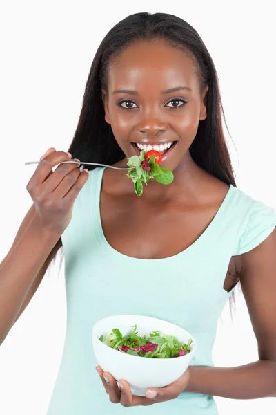 Smiling young woman having a snack — Stock Photo, Image