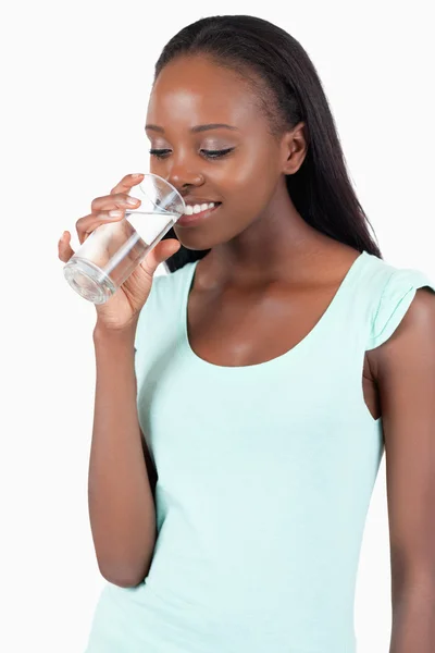 Junge Frau blickt in ihr Wasserglas — Stockfoto