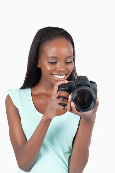 Young photographer taking a look at her cam — Stock Photo, Image