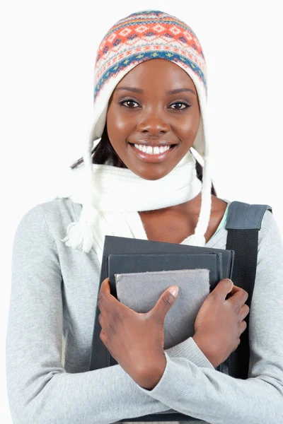 Close up of woman with winter clothes and books — Stock Photo, Image