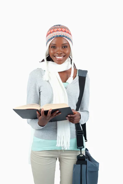 Smiling young student in winter clothing and book — Stock Photo, Image