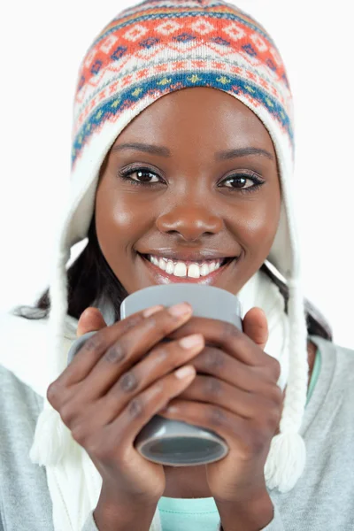 Smiling woman warming up with a cup of tea — Stock Photo, Image