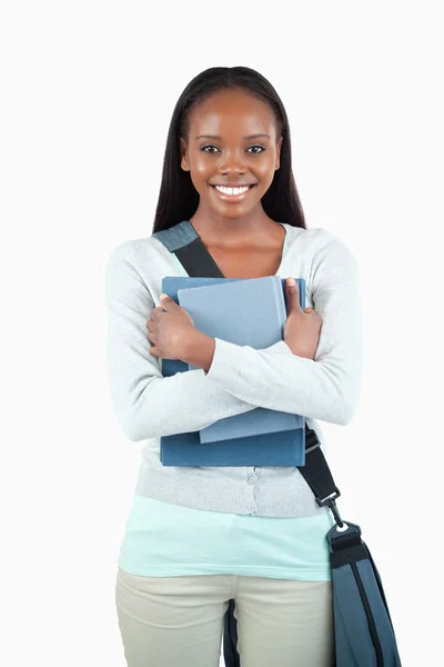 Smiling young female student with books and bag — Stock Photo, Image