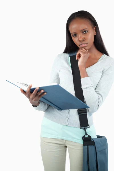 Young student with her book thinking — Stock Photo, Image