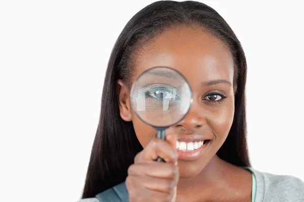 Young woman with magnifier — Stock Photo, Image