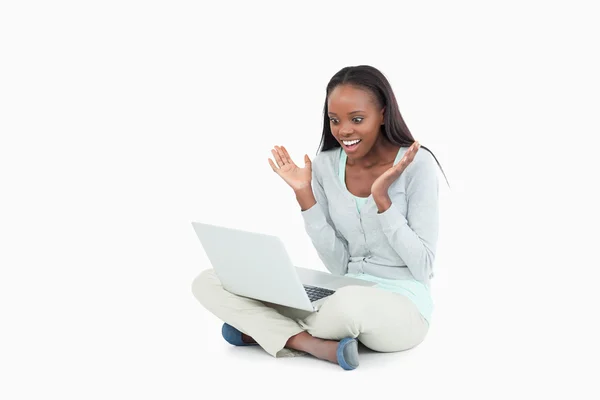 Young woman happy about whats on her screen — Stock Photo, Image