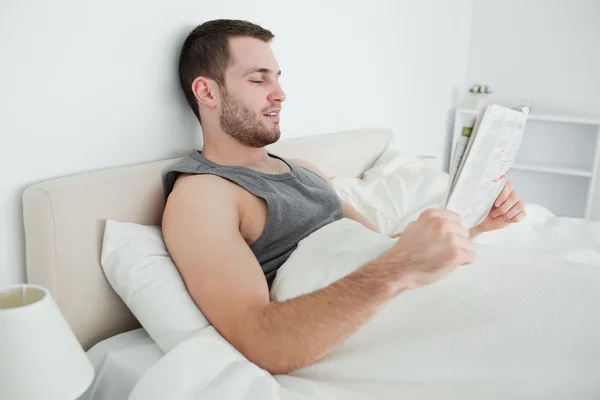 Beautiful man reading a newspaper — Stock Photo, Image