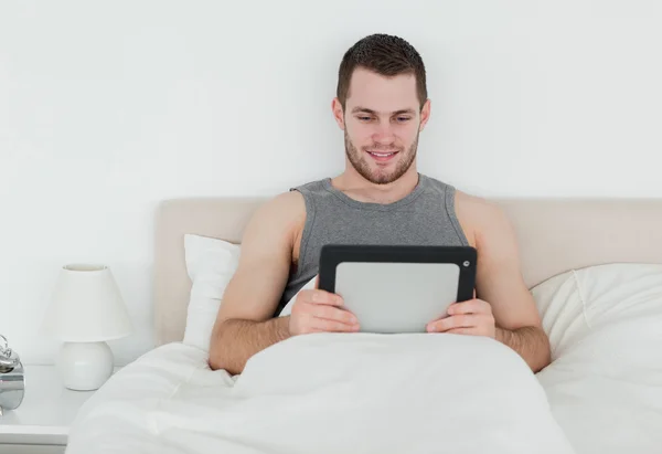Handsome man using a tablet computer — Stock Photo, Image