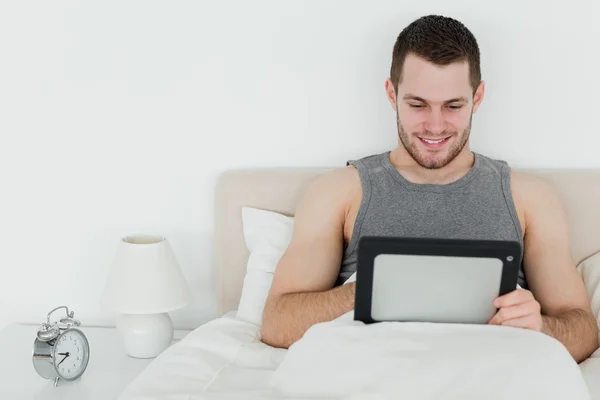 Peaceful man using a tablet computer — Stock Photo, Image