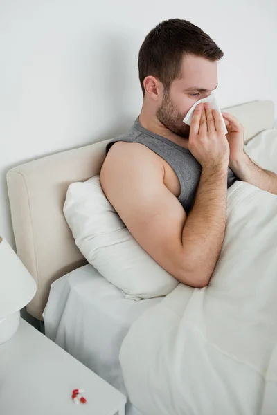 Portrait of a man blowing his nose — Stock Photo, Image