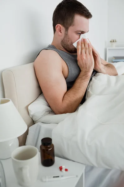 Portrait of a sick man blowing his nose — Stok Foto