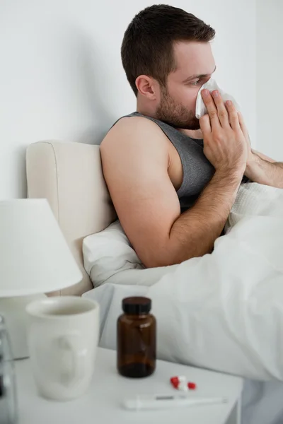 Portrait of a handsome man blowing his nose — Stock Photo, Image