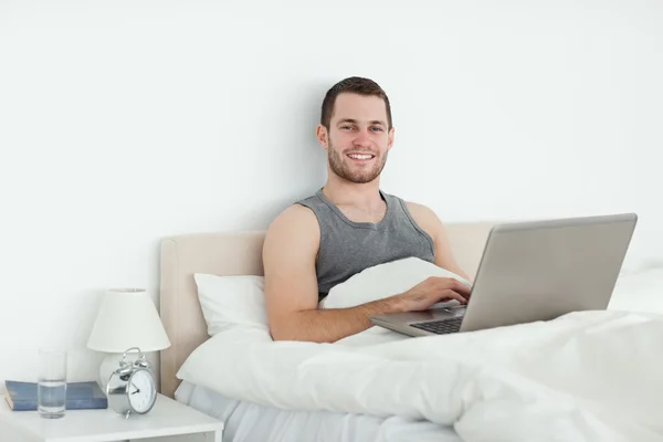 Serene man using a laptop — Stock Photo, Image