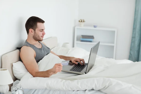 Handsome man purchasing online — Stock Photo, Image