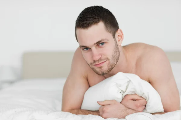 Handsome man lying on his belly — Stock Photo, Image