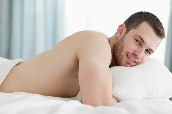 Calm man lying on his belly — Stock Photo, Image