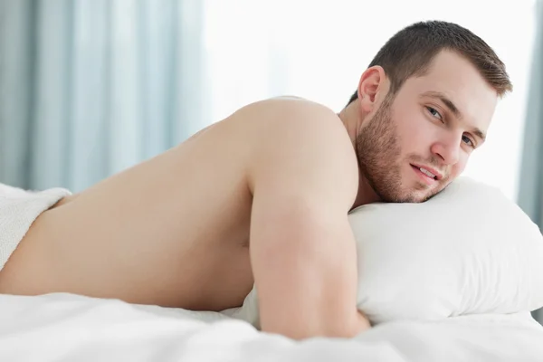 Serene man lying on his belly — Stock Photo, Image