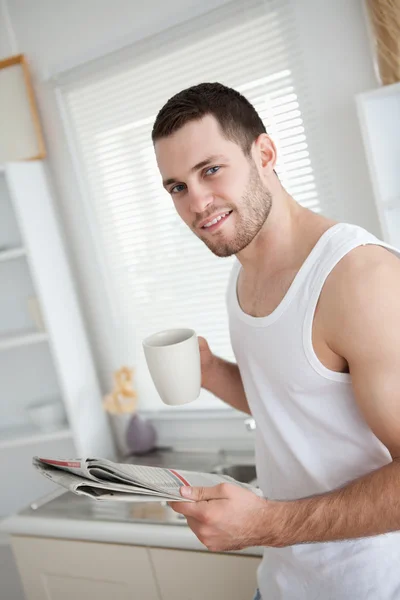 stock image Delighted man drinking coffee while reading the news