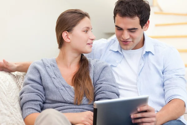 Engaged couple using a tablet computer — Stock Photo, Image