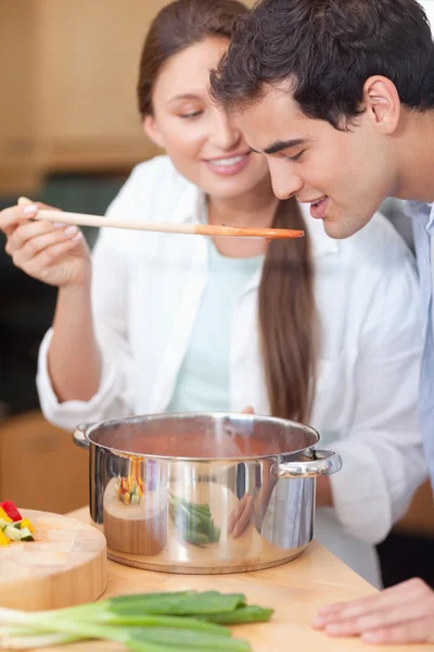 Portrait of a man trying his wife's sauce — Stock Photo, Image