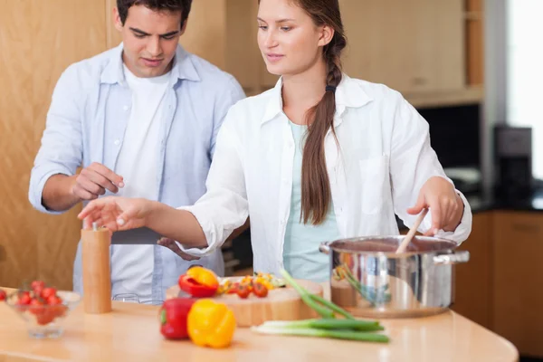 Cute couple using a tablet computer to cook — Stock Photo, Image