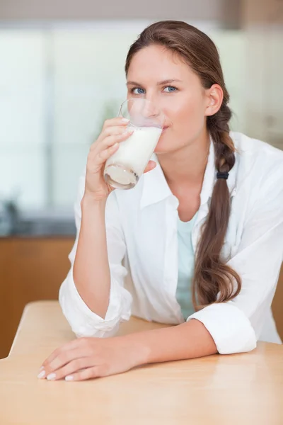 Portrait of a cute woman drinking milk — Stock Photo, Image