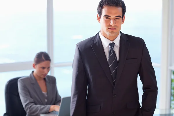 Businessman with his secretary behind him — Stock Photo, Image